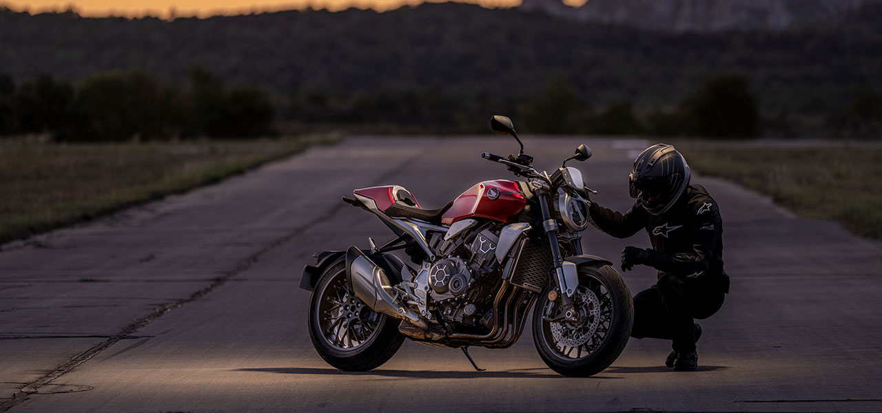 biker looking at the braking system of a motorbike